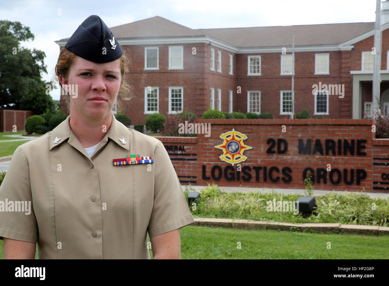 Petty Officer 3rd Class Elizabeth J. Miller, a corpsman with Combat Logistics Regiment 25 and native of Boaz, Alabama, poses for a picture in front of the 2nd Marine Logistics Group building September 19, 2014. Larry T. Flesher, an electrical technician and native of Valdosta, Georgia, crashed his car into oncoming traffic the morning of September 12, 2014, while crossing the Sneads Ferry Bridge on his way to work on Camp Lejeune. With the help of two Marines, Miller was able to pull Flesher from his car and perform first aid until the arrival of emergency medical services. Flesher lived thank Stock Photo