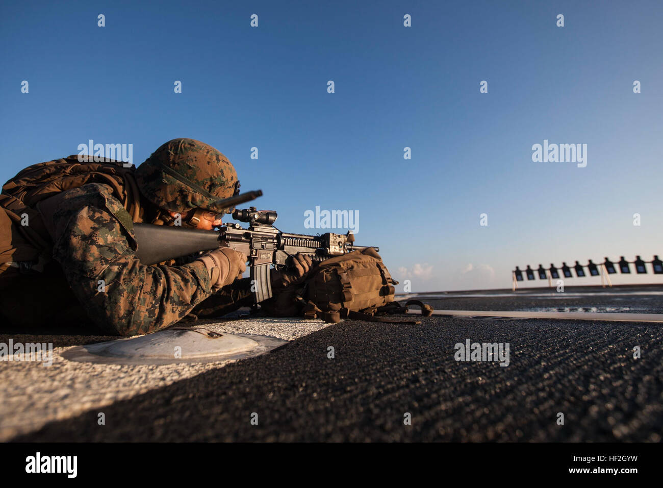 Corporal Carlos Eduardothen, an infantryman with Company L, Battalion Landing Team 3rd Battalion, 5th Marines, 31st Marine Expeditionary Unit, and a native of Perth Amboy, New Jersey, engages a target during a deck shoot on the USS Germantown (LSD-42). The 31st MEU/USS Peleliu (LHA-5) Amphibious Ready Group is executing Certification Exercise in preperation for Fall Patrol of the Asia-Pacific region. (U.S. Marine photo by Cpl. Henry Antenor) 31st MEU Fall Patrol 2014 CERTEX 140926-M-FX659-227 Stock Photo