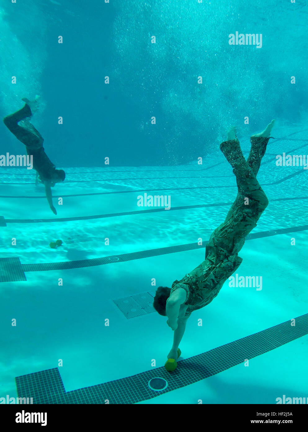 Members of the British Royal Marines retrieve 25 pound weights during
