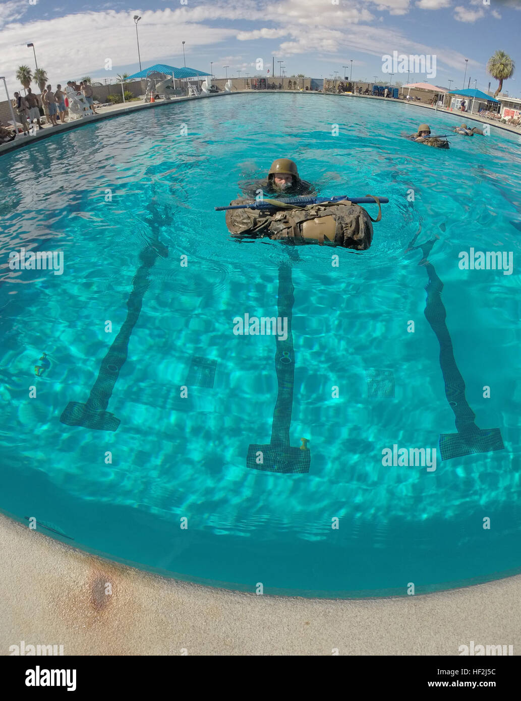 Members of the British Royal Marines swim with rifles, flak jackets and assualt packs during an