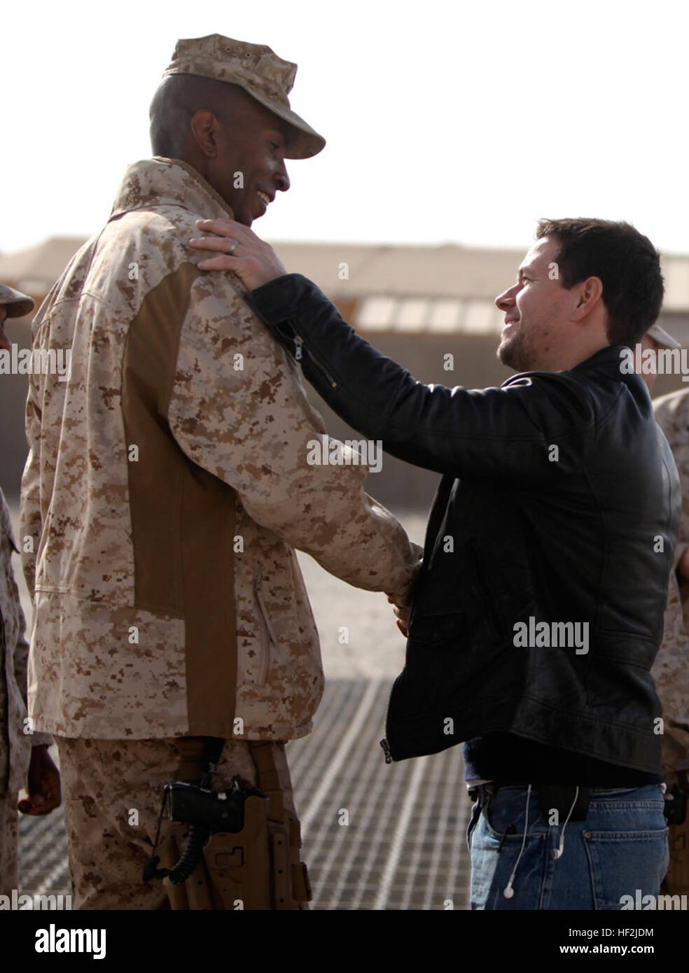 Maj. Larry Parker, executive officer, Headquarters and Service Company, 1st Marine Logistics Group (Forward), shakes hands with actor Mark Wahlberg during Wahlberg's visit to Camp Leatherneck, Afghanistan, Dec. 19. Wahlberg shook hands and took pictures with service members while thanking them for their service. More than 100 anxious fans waited in line to meet Wahlberg. Mark Wahlberg and Marine Major Larry Parker in Afghanistan Stock Photo