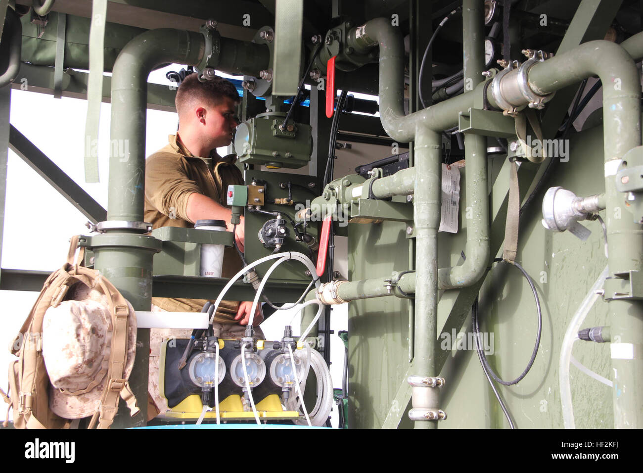 Lance Cpl. Joel Arndt, a water support technician with Marine Wing Support Squadron 373, monitors the gages of the Tactical Water Purification System at Marine Corps Base Camp Pendleton during exercise Pacific Horizon 2015, Oct. 23. PH 15 increases the ability of 1st Marine Expeditionary Brigade and Expeditionary Strike Group 3 to plan, communicate and conduct complex sea and shore based operations in response to natural disasters. (U.S. Marine Corps photo by Lance Cpl. Caitlin Bevel) Marines wash away thirst at exercise Pacific Horizon 141023-M-MP944-026 Stock Photo