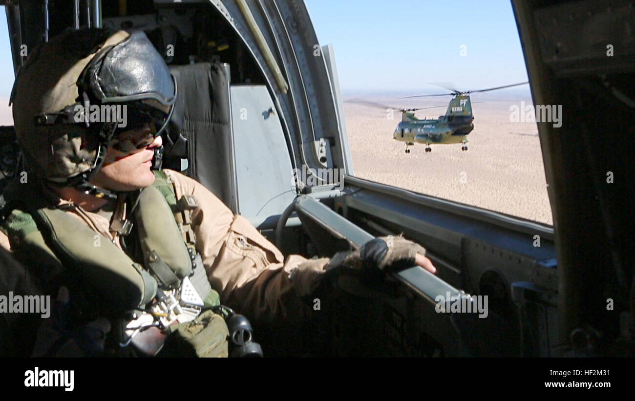 Staff Sgt. Derek Burleson, a crew chief with Marine Medium Tiltrotor Squadron (VMM) 364, looks out the window during the last CH-46E flight on the way to Davis-Monthan Air Force Base, Ariz., Oct. 29. The squadron will transfer to the MV-22B Osprey after the aircraft is inducted into the 309th Aerospace Maintenance and Regeneration Group. Purple Foxes retire last 'Phrog' 141029-M-CJ278-001 Stock Photo
