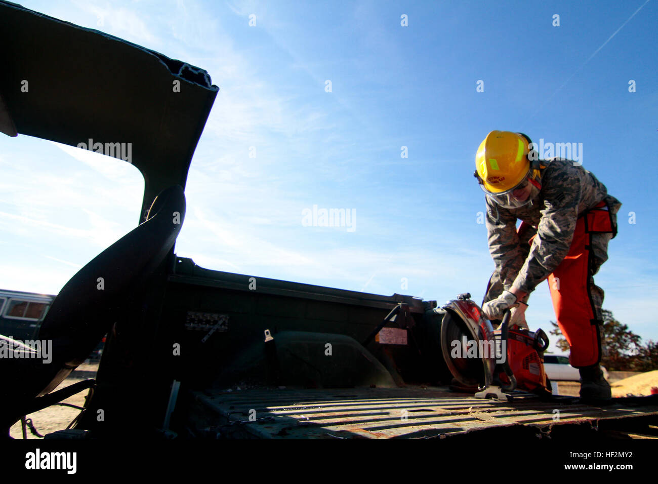 A U.S. Air Force Airmen from the New Jersey Air National Guard's 177th Fighter Wing uses a rescue saw on a truck at Warren Grove Gunnery Range, N.J., Nov. 8, 2014. The Airman, who is part of the Crashed Damaged Disabled Aircraft Recovery (CDDAR) team, was getting familiarization training on new equipment. (U.S. Air National Guard photo by Tech. Sgt. Matt Hecht/Released) Aircraft recovery team trains with reclamation equipment 141108-Z-NI803-196 Stock Photo