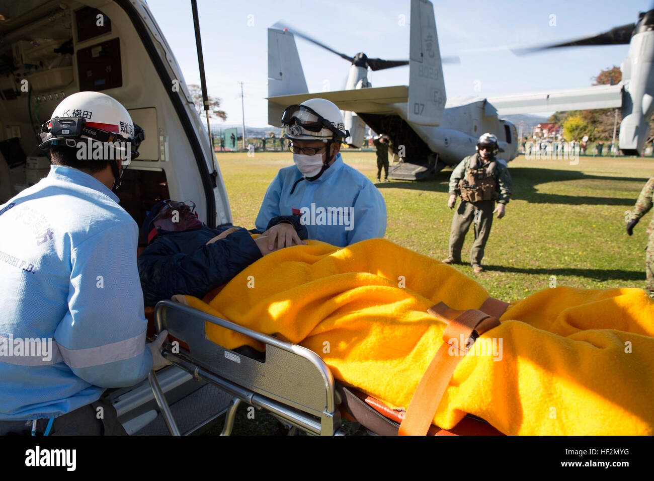 Emergency medical technicians with the Oshima Fire Department transfer a notionally wounded victim to an MV-22B Osprey tiltrotor aircraft Nov. 8 during Tomodachi relief exercise 15.2 near Izu Oshima Island, Tokyo Metropolis Prefecture, Japan. TREX 15.2 is an annual, bilateral training exercise that simulates humanitarian assistance and disaster relief missions in Japan while strengthening the U.S. and Japanese alliance. In less than eight minutes, more than 600 pounds of relief supplies were offloaded from an Osprey so two notionally wounded victims could evacuated. (U.S. Marine Corps photo by Stock Photo
