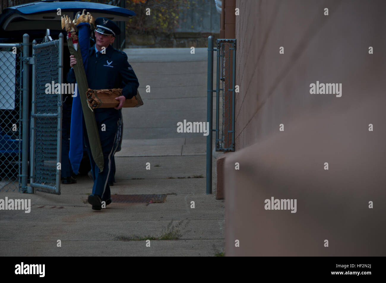 Airman 1st Class Hunter Mitchell carries ceremonial flags into the