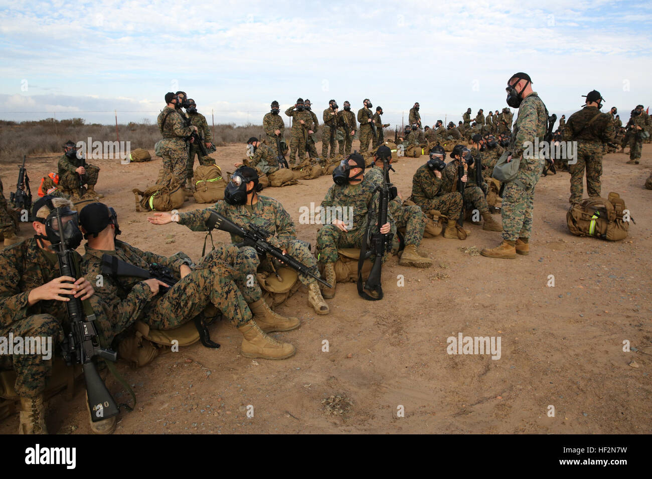 Marines with Marine Wing Communications Squadron (MWCS) 38 wear their gas masks during a six-mile hike through the east side of Marine Corps Air Station Miramar, Calif., Nov. 14, as part of an annual birthday tradition. The Marine of MWCS-38 practiced their readiness for chemical biological radiological neurological defense while on the hike. Marines of MWCS-38 use training to help celebrate birthday 141117-M-RB277-004 Stock Photo