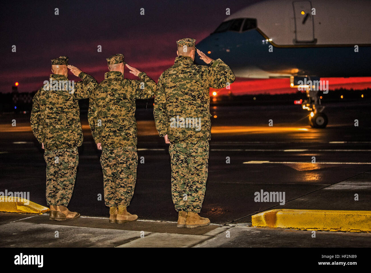 From left to right, U.S. Marine Corps Col. Matthew G. St. Clair, SgtMaj. Bryan K. Zickefoose, and Maj. Gen. William D. Beydler, salute the arriving plane of the U.S. Secretary of Defense, the Honorable Mr. Chuck Hagel, at Marine Corps Air Station New River, N.C., Nov. 17, 2014. Hagel visited Camp Lejeune as part of his tour of military installations across the country. (U.S. Marine Corps photo by Cpl. Desire M. Mora/Released) US Secretary of Defense, The Honorable Mr. Chuck Hagel, arrives for visit to Marine Corps Base Camp Lejeune, NC 141117-M-TG562-001 Stock Photo