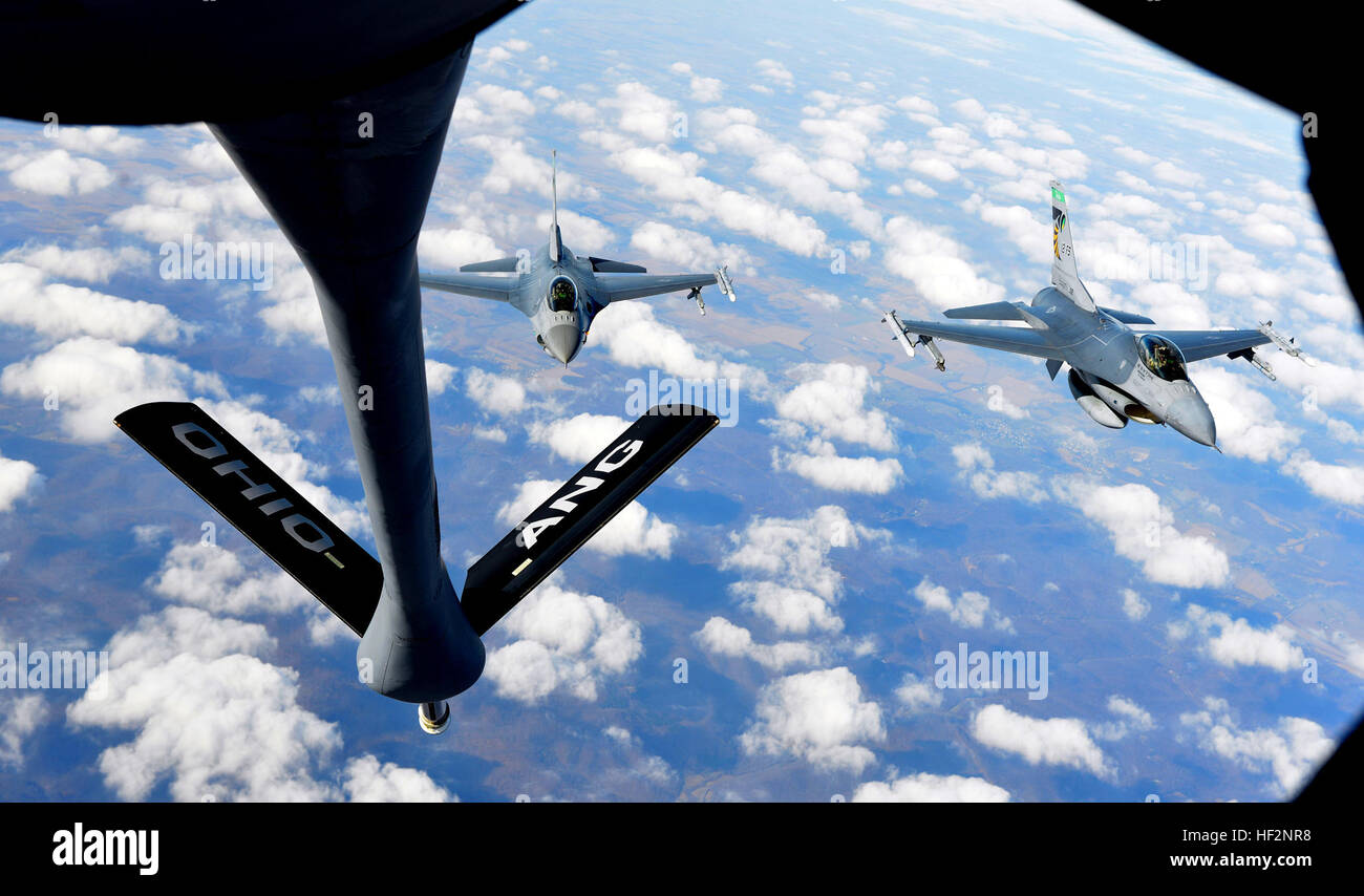 Two F-16 Fighting Falcons from the 180th Fighter Wing, Toledo, Ohio, fly behind a KC-135 Stratotanker from the 121st Air Refueling Wing Nov. 26, 2014, in the skies above Ohio. The fighters just received fuel from Chief Master Sgt. Tom Guard, 121st Air Refueling Wing boom operator, on his final flight after 41 years of service. (U.S. Air National Guard photo by Master Sgt. Ralph Branson/Released) Final flight 141126-Z-uu033-189 Stock Photo