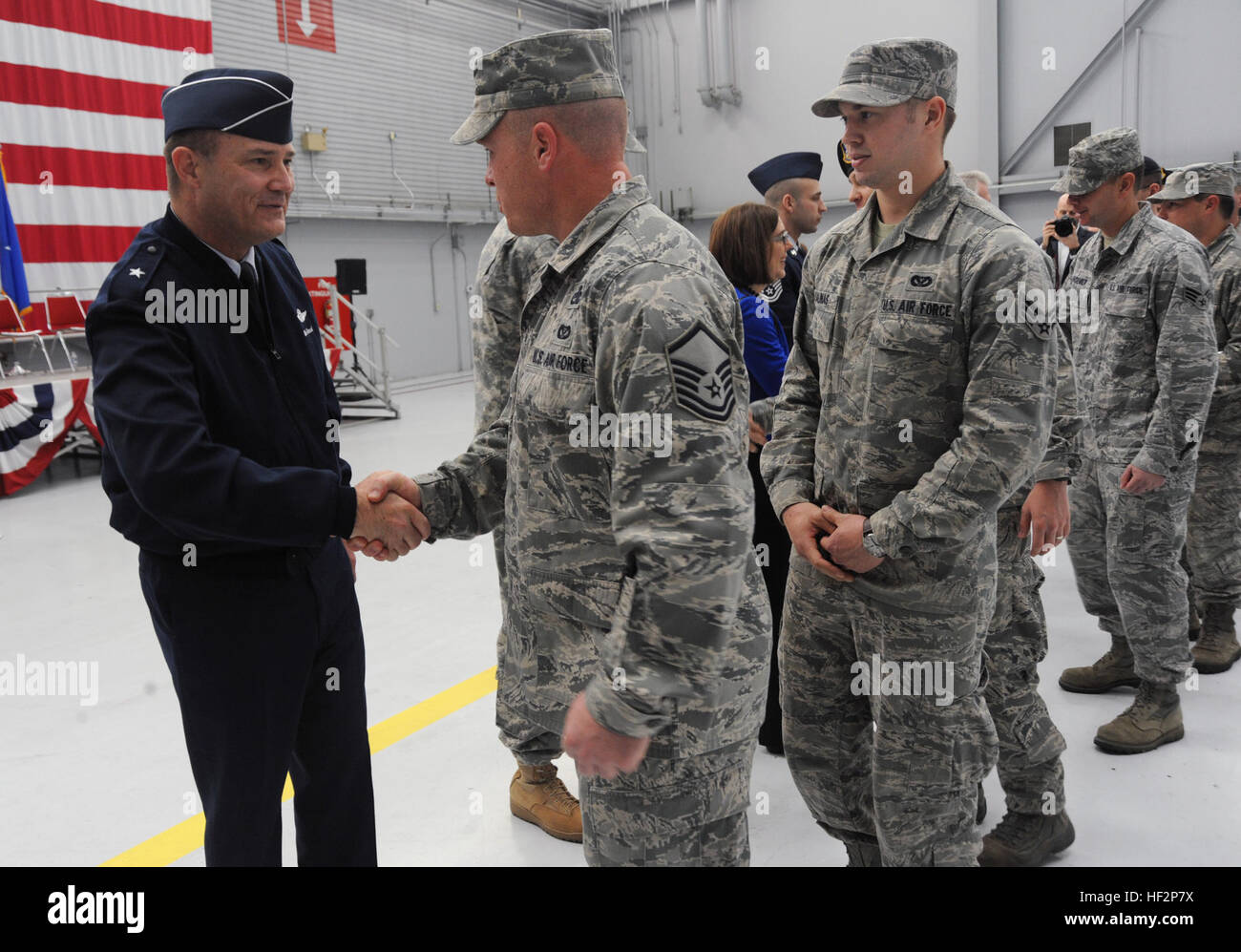 Brig. Gen. Michael Stencel, Oregon Air National Guard commander, left, greets Airmen from the 142nd Fighter Wing Civil Engineer Squadron and Security Forces Squadron after the formal demobilization ceremony at the Portland Air National Guard Base, Ore., Dec. 7, 2014. (U.S. Air National Guard photo by Tech. Sgt. John Hughel, 142nd Fighter Wing Public Affairs/Released) Airmen return from OEF deployment 141207-Z-CH590-242 Stock Photo