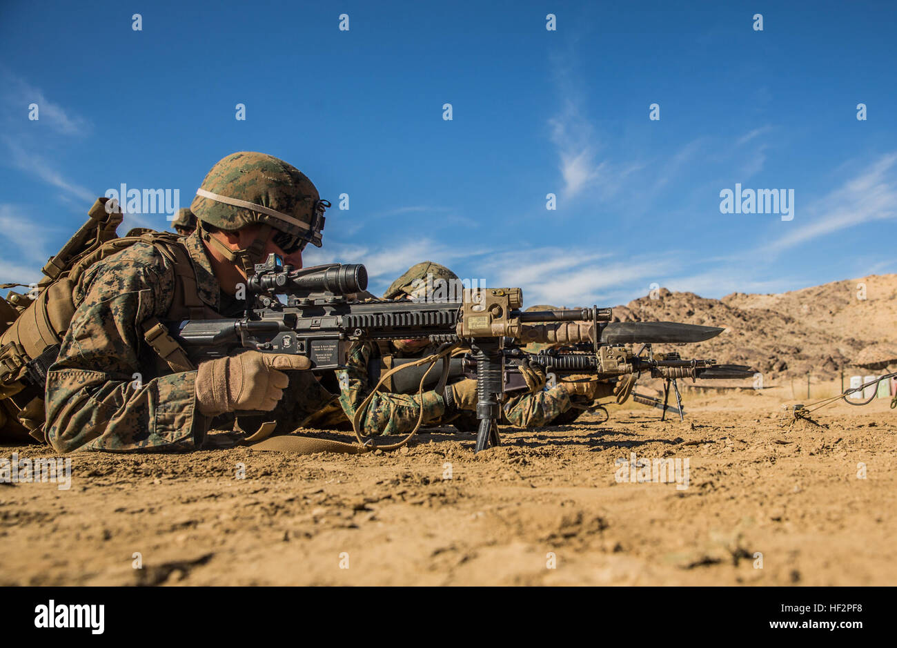 U.S. Marines with Battalion Landing Team 3rd Battalion, 1st Marine Regiment, 15th Marine Expeditionary Unit, conduct marksmanship drills during a combined arms exercise aboard Marine Corps Air Ground Combat Center, Twentynine Palms, Calif., Dec. 10, 2014. BLT 3/1 conducted this training concurrent with the 15th MEU’s realistic urban training.  RUT prepares the 15th MEU’s Marines for their upcoming deployment, enhancing their combat skills in environments similar to those they may find in future missions. (U.S. Marine Corps Photo by Sgt. Emmanuel Ramos/Released) 15th MEU Marines train in combin Stock Photo