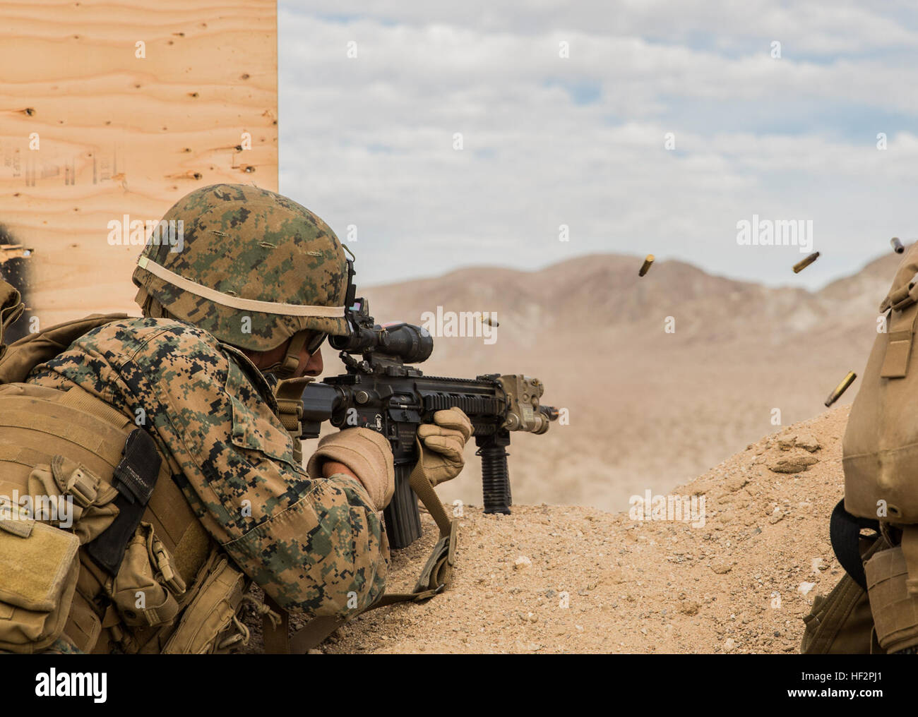 U.S. Marine Lance Cpl. Joseph Burke engages targets during a combined arms exercise aboard Marine Corps Air Ground Combat Center, Twentynine Palms, Calif., Dec. 11, 2014. Burke is a team leader with Battalion Landing Team 3rd Battalion, 1st Marine Regiment, 15th Marine Expeditionary Unit. BLT 3/1 conducted this training concurrent with the 15th MEU’s realistic urban training.  RUT prepares the 15th MEU’s Marines for their upcoming deployment, enhancing their combat skills in environments similar to those they may find in future missions. (U.S. Marine Corps Photo by Sgt. Emmanuel Ramos/Released Stock Photo