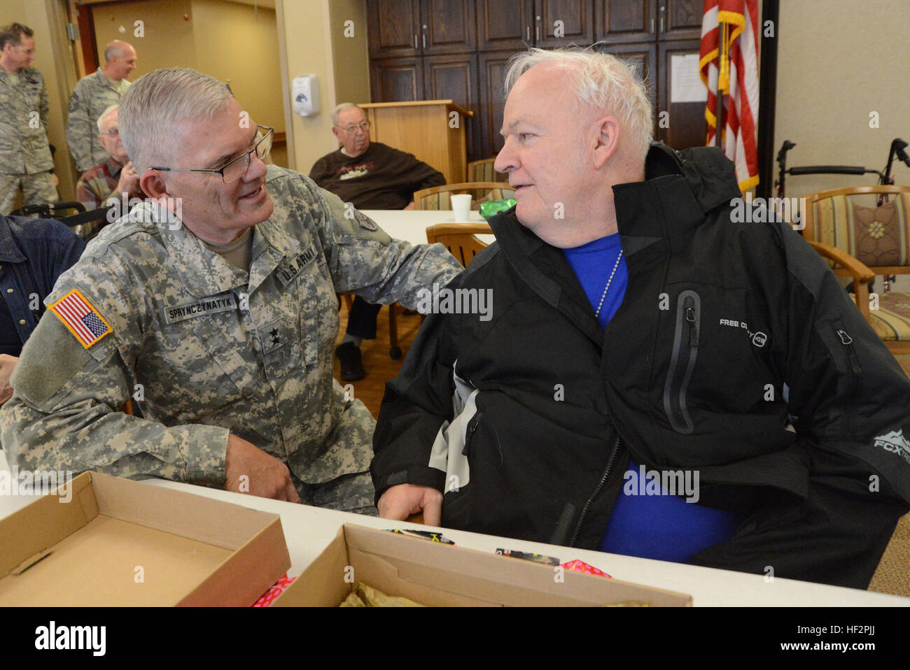 Maj. Gen. David Sprynczynatyk, N.D. adjutant general, speaks with Ben