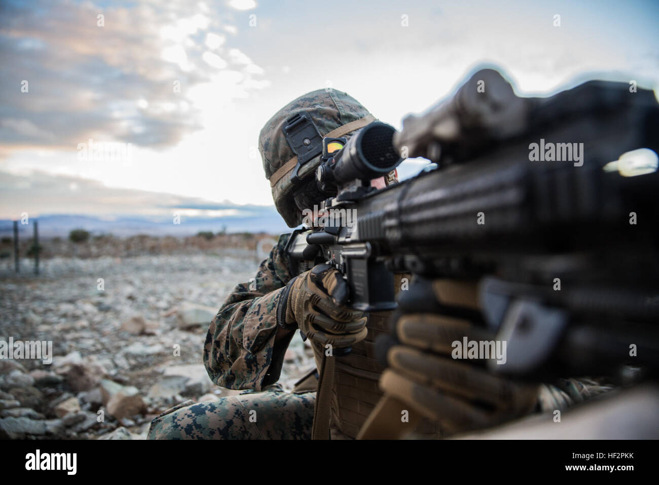 U.S. Marine Lance Cpl. Trent Martin aims in on a target during a combined arms exercise aboard Marine Corps Air Ground Combat Center, Twentynine Palms, Calif., Dec. 12, 2014. Martin is a rifleman with Battalion Landing Team 3rd Battalion, 1st Marine Regiment, 15th Marine Expeditionary Unit. BLT 3/1 conducted this training concurrent with the 15th MEU’s realistic urban training.  RUT prepares the 15th MEU’s Marines for their upcoming deployment, enhancing their combat skills in environments similar to those they may find in future missions. (U.S. Marine Corps Photo by Sgt. Emmanuel Ramos/Releas Stock Photo