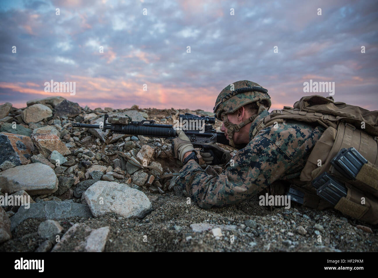 U.S. Marine Lance Cpl. Zachary Thompson aims in on a target during a combined arms exercise aboard Marine Corps Air Ground Combat Center, Twentynine Palms, Calif., Dec. 12, 2014. Thompson is a rifleman with Battalion Landing Team 3rd Battalion, 1st Marine Regiment, 15th Marine Expeditionary Unit.  BLT 3/1 conducted this training concurrent with the 15th MEU’s realistic urban training.  RUT prepares the 15th MEU’s Marines for their upcoming deployment, enhancing their combat skills in environments similar to those they may find in future missions. (U.S. Marine Corps Photo by Sgt. Emmanuel Ramos Stock Photo