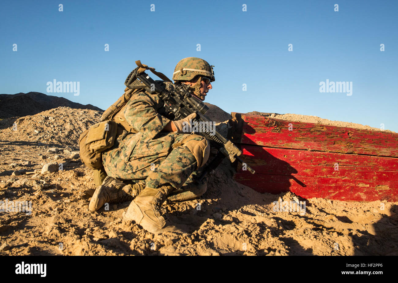 U.S. Marine Lance Cpl. Joseph Burke prepares to engage targets during a combined arms training aboard Marine Corps Air Ground Combat Center, Twentynine Palms, Calif., Dec. 13, 2014. Burke is a team leader with Battalion Landing Team 3rd Battalion, 1st Marine Regiment, 15th Marine Expeditionary Unit. BLT 3/1 conducted this training concurrent with the 15th MEU’s realistic urban training.  RUT prepares the 15th MEU’s Marines for their upcoming deployment, enhancing their combat skills in environments similar to those they may find in future missions. (U.S. Marine Corps Photo by Sgt. Emmanuel Ram Stock Photo