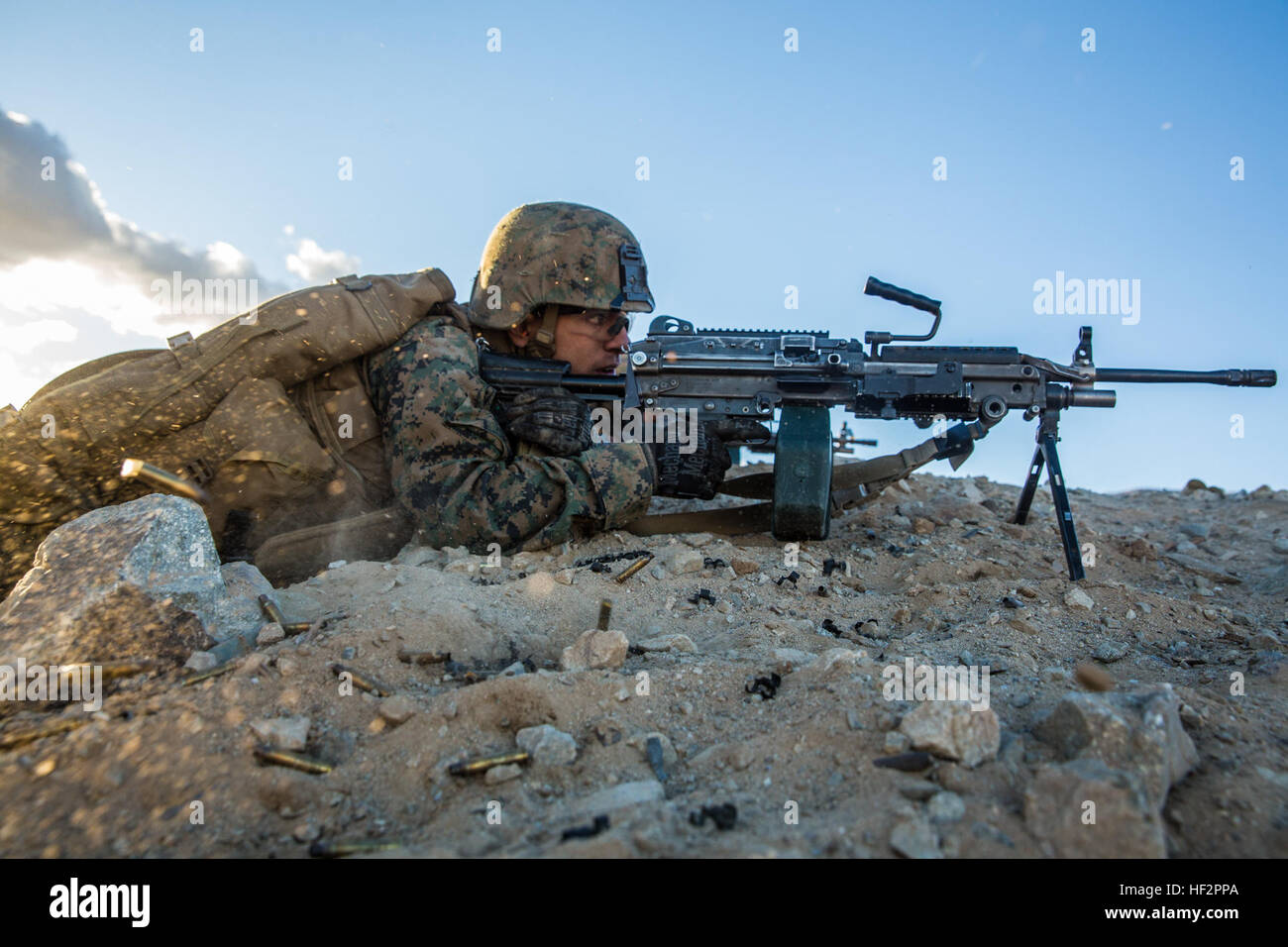 U.S. Marine Pfc. Andres Bravo engages targets during a combined arms exercise aboard Marine Corps Air Ground Combat Center, Twentynine Palms, Calif., Dec. 13, 2014. Bravo is a rifleman with Battalion Landing Team 3rd Battalion, 1st Marine Regiment, 15th Marine Expeditionary Unit. BLT 3/1 conducted this training concurrent with the 15th MEU’s realistic urban training.  RUT prepares the 15th MEU’s Marines for their upcoming deployment, enhancing their combat skills in environments similar to those they may find in future missions. (U.S. Marine Corps Photo by Sgt. Emmanuel Ramos/Released) 15th ME Stock Photo