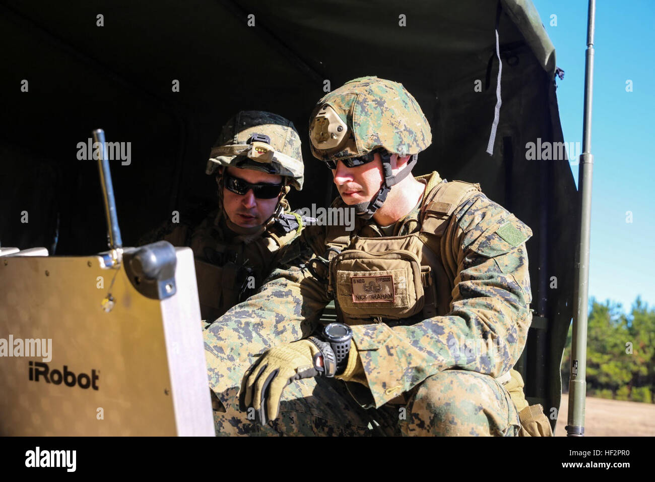Explosive Ordnance Disposal technicians operate robots during field ...