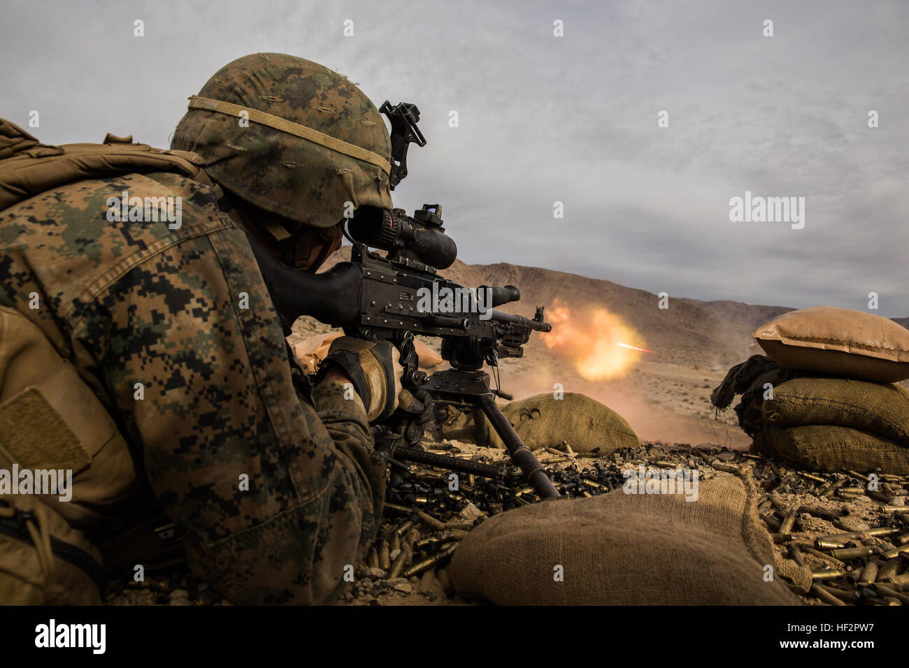 U.S. Marine Lance Cpl. Nathan Metzger engages targets during a combined arms exercise aboard Marine Corps Air Ground Combat Center, Twentynine Palms, Calif., Dec. 15, 2014. Metzger is a machine gunner with Battalion Landing Team 3rd Battalion, 1st Marine Regiment, 15th Marine Expeditionary Unit. BLT 3/1 conducted this training concurrent with the 15th MEU’s realistic urban training. RUT prepares the 15th MEU’s Marines for their upcoming deployment, enhancing their combat skills in environments similar to those they may find in future missions. (U.S. Marine Corps Photo by Sgt. Emmanuel Ramos/Re Stock Photo