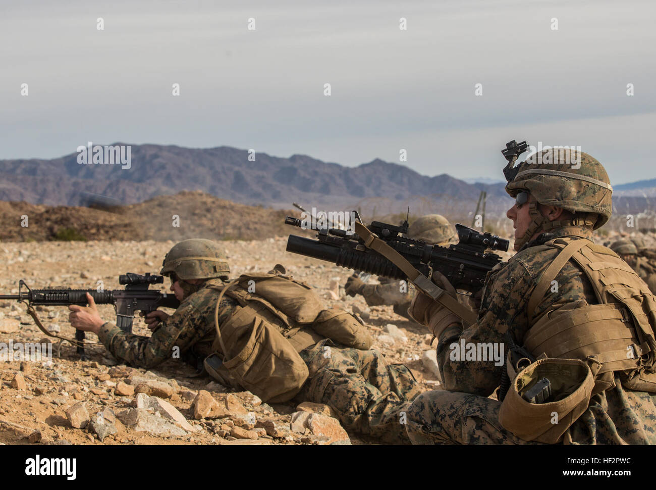 U.S. Marine Lance Cpl. Corey W. Dahmen, right, engages targets during a combined arms exercise aboard Marine Corps Air Ground Combat Center, Twentynine Palms, Calif., Dec. 15, 2014. Dahmen is a team leader with Battalion Landing Team 3rd Battalion, 1st Marine Regiment, 15th Marine Expeditionary Unit. BLT 3/1 conducted this training concurrent with the 15th MEU’s realistic urban training.  RUT prepares the 15th MEU’s Marines for their upcoming deployment, enhancing their combat skills in environments similar to those they may find in future missions. (U.S. Marine Corps Photo by Sgt. Emmanuel Ra Stock Photo