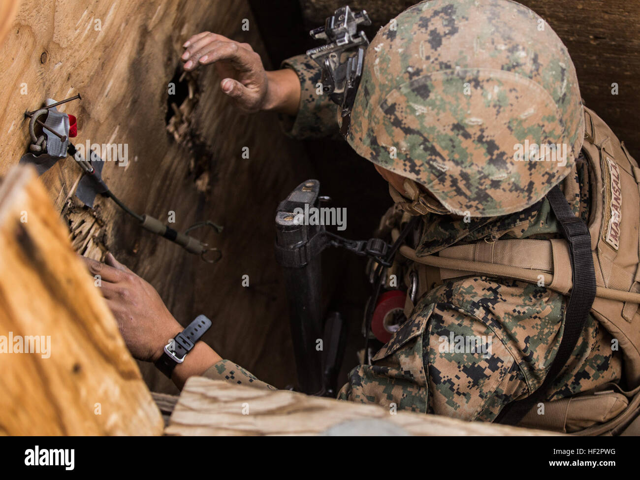 U.S. Marine Lance Cpl. Estelito Manansala places a donut charge during a combined arms exercise  aboard Marine Corps Air Ground Combat Center, Twentynine Palms, Calif., Dec. 15, 2014. Manansala is a combat engineer with Battalion Landing Team 3rd Battalion Team, 15th Marine Expeditionary Unit. BLT 3/1 conducted this training concurrent with the 15th MEU’s realistic urban training.  RUT prepares the 15th MEU’s Marines for their upcoming deployment, enhancing their combat skills in environments similar to those they may find in future missions. (U.S. Marine Corps Photo by Sgt. Emmanuel Ramos/Rel Stock Photo