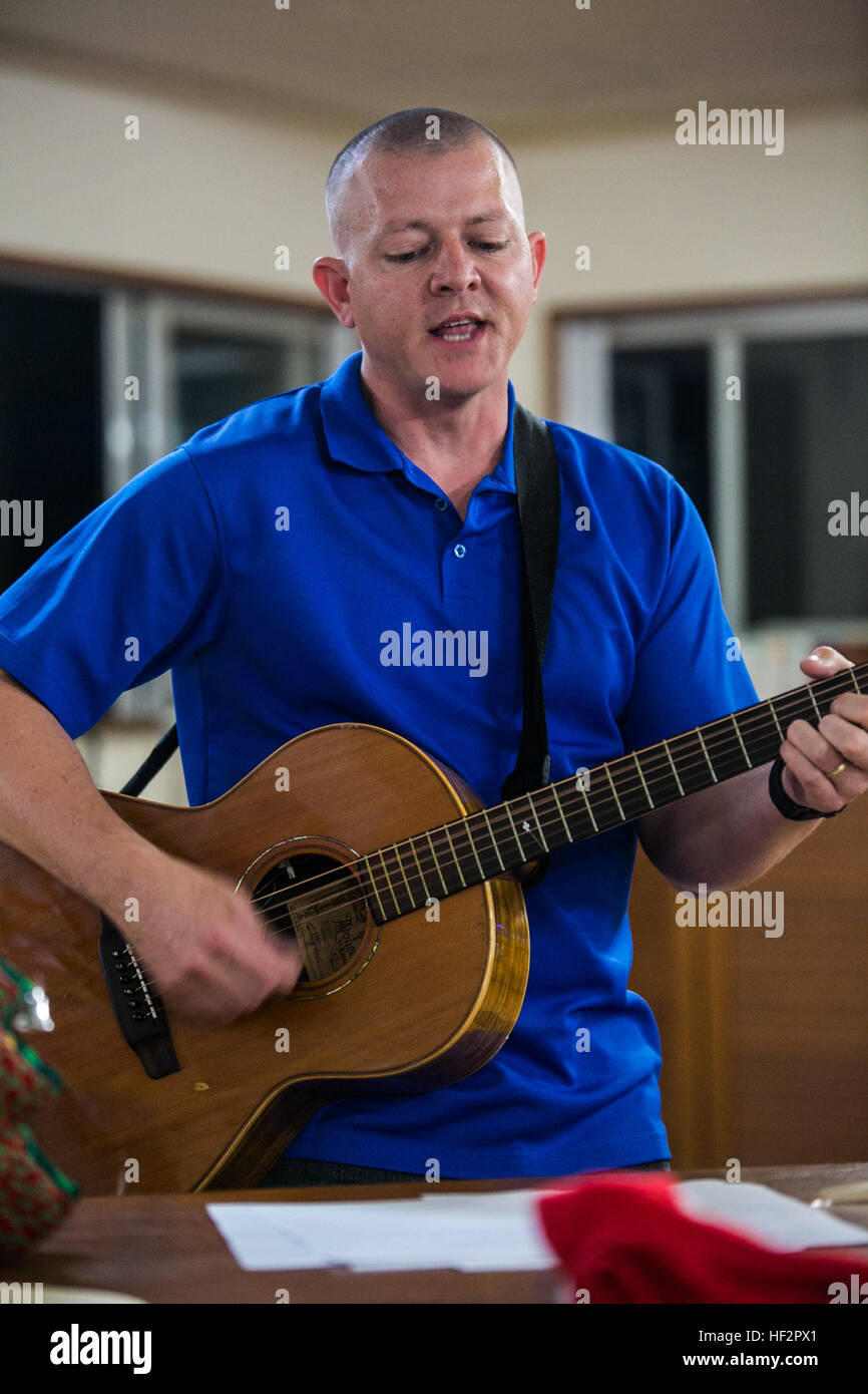 U.S. Navy Lt. Steven G. Hervey sings and plays the song “Jingle Bells