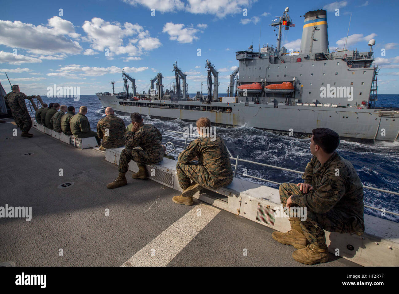 Marines with the 24th Marine Expeditionary Unit watch as the USNS Kanawha maneuver itself into position in preparation for a replenishment-at-sea aboard the USS New York, Dec. 30, 2014. The 24th MEU and Iwo Jima Amphibious Ready Group are conducting naval operations in the U.S. 6th Fleet area of operations in support of U.S. national security interests in Europe. (U.S. Marine Corps photo by Cpl. Todd F. Michalek) 24th Marine Expeditionary Unit Participates in Resupply-At-Sea Operations Aboard USS New York 141230-M-YH418-001 Stock Photo