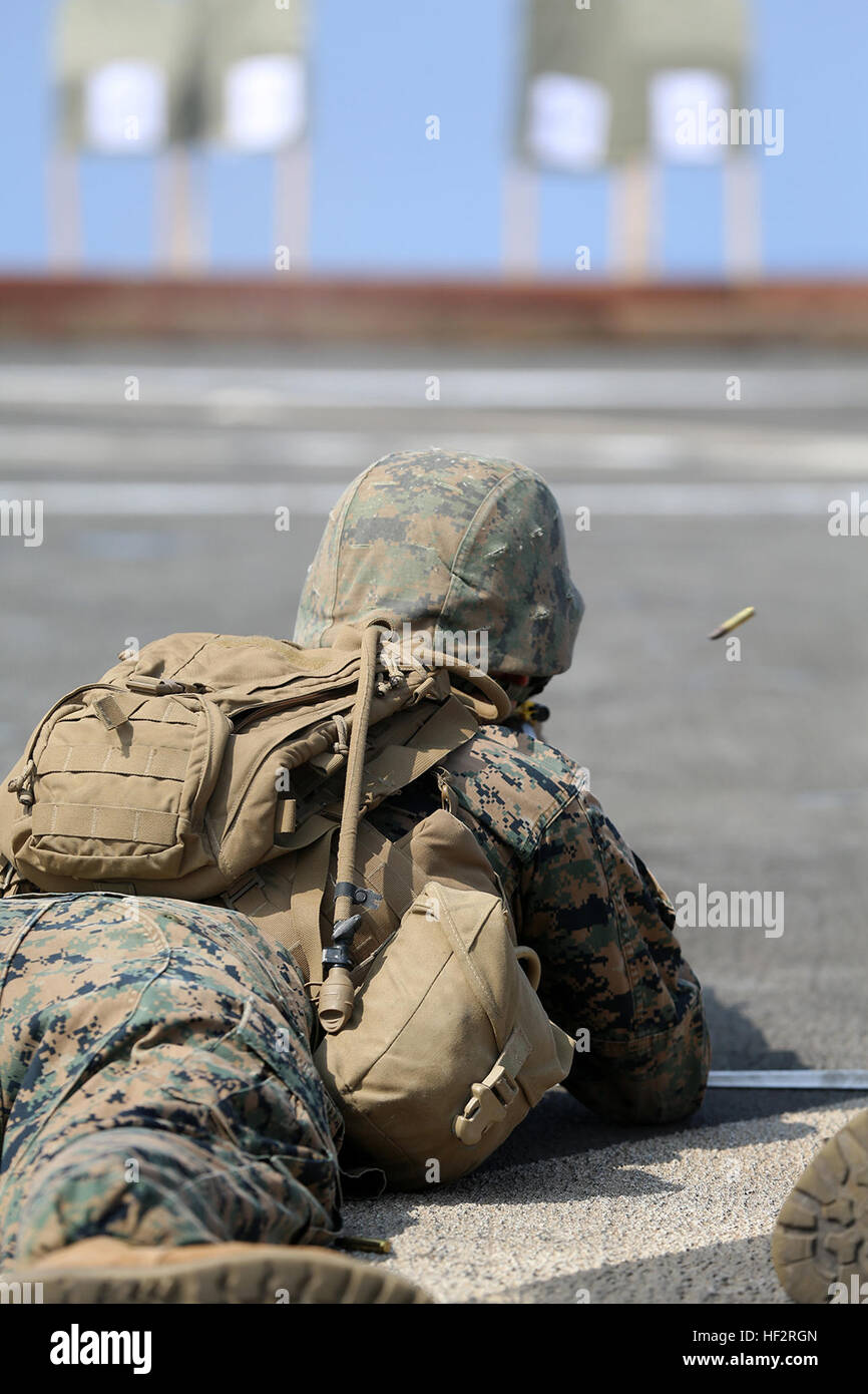 Lance Cpl. Mckenzie Lee, a water support technician with Combat Logistics Battalion 11, 11th Marine Expeditionary Unit (MEU), from Murfreesboro, Tennessee, engages a target during an advanced combat marksmanship program shoot on the flight deck of the dock landing ship USS Comstock (LSD 45), Jan. 9. The 11th MEU is deployed with the Makin Island Amphibious Ready Group (ARG) as a theater reserve and crisis response force throughout U.S. 5th Fleet and U.S. 7th Fleet areas of responsibility. (U.S. Marine Corps photo by Sgt. Melissa Wenger/Released) CLB-11 maintains weapon proficiency on USS Comst Stock Photo