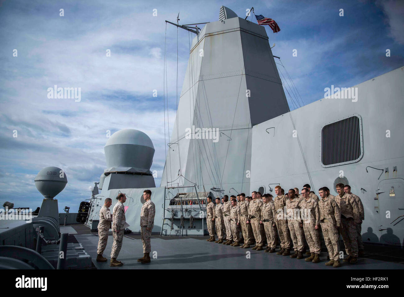 Marines with Combat Logistics Battalion 24, 24th Marine Expeditionary Unit, stand in formation during a promotion ceremony aboard the USS New York, at sea, Jan. 10, 2015. The 24th MEU and Iwo Jima Amphibious Ready Group are conducting naval operations in the U.S. 6th Fleet of operations in support of U.S. national security interests in Europe. (U.S. Marine Corps photo by Cpl. Todd F. Michalek) 24th MEU Promotion-At-Sea 150110-M-YH418-001 Stock Photo