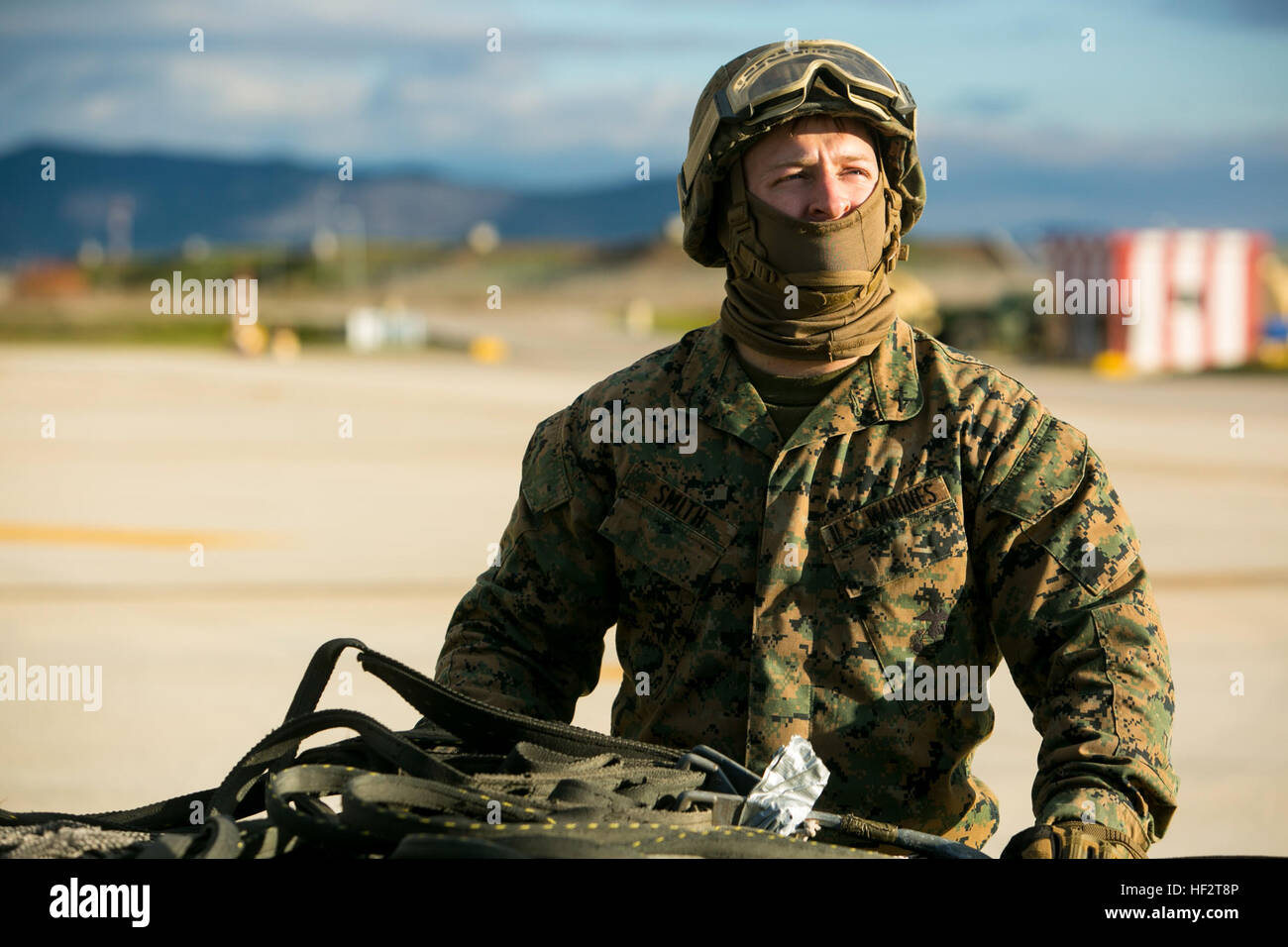 Lance Cpl. Derek Smith, a landing support specialist with Special-Purpose Marine Air-Ground Task Force Crisis Response-Africa, stands on the flight line at Morón Air Base, Spain, during an external-lift drill with the MV-22 Osprey Jan. 19, 2015. Smith worked with a team of landing support specialists to connect a 2180-pound pallet to the lift-cable of an Osprey. (U.S. Marine Corps photo by Sgt. Paul Peterson) Embracing the Whirlwind, Crisis Response Marines hone heavy-lift capabilities in Spain 150119-M-ZB219-333 Stock Photo