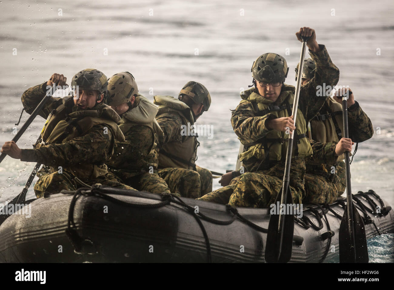 U.S. Marines with Company F, Battalion Landing Team (BLT) 2nd Battalion, 4th Marines, 31st Marine Expeditionary Unit (MEU) paddle off the stern gate of the USS Bonhomme Richard (LHD 6) using a Combat Rubber Raiding Craft, at sea, Feb. 2, 2015. The Marines and sailors use launch and recovery drills to prepare for the 31st MEU's spring patrol of the Asia-Pacific region. (U.S. Marine Corps photo by Lance Cpl. Brian Bekkala/Released) Boat Operations 150202-M-GR217-107 Stock Photo
