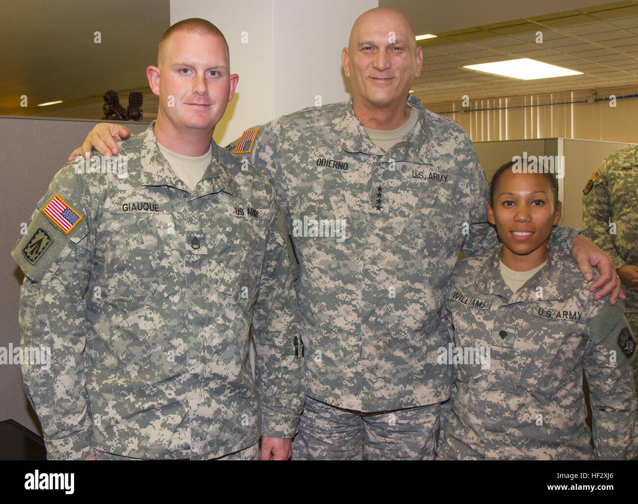 Chief of Staff of the Army Gen. Raymond T. Odierno poses for a photo with Staff Sgt. Mark Giauque, the early warning section noncommissioned officer in charge, and Spc. Christina Williams, the senior local area network analyst, 94th Army Air and Missile Defense Command, during his site tour of the 94th AAMDC’s Headquarters, Feb. 11, 2015, at Joint Base Pearl Harbor-Hickam, Hawaii. Giauque is the Noncommissioned Officer of the Year and Williams is the Soldier of the Year for the 94th AAMDC. (U.S. Army Photo by Sgt. Kimberly K. Menzies, 94th AAMDC Public Affairs) Chief of staff of the Army visit Stock Photo
