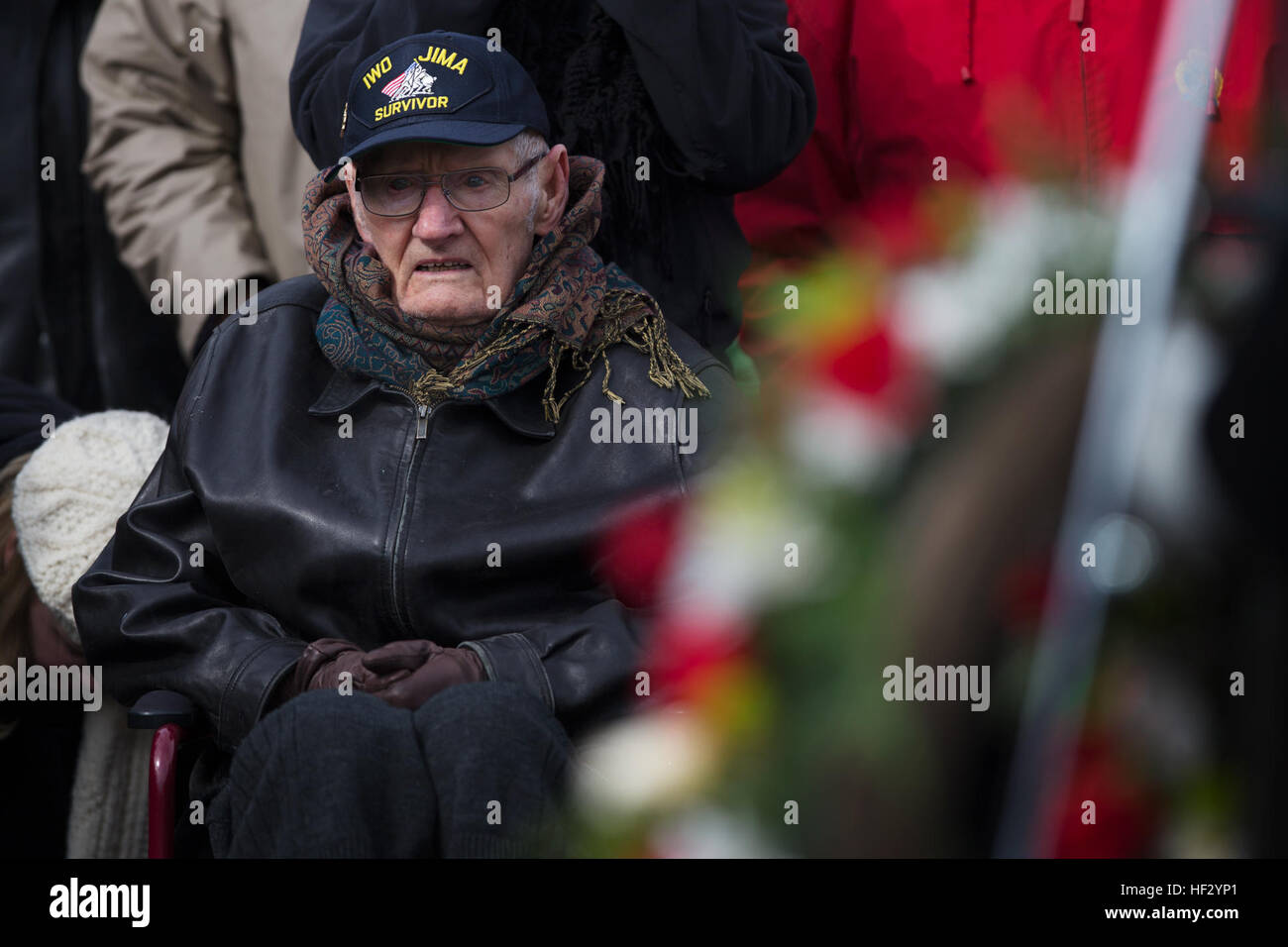 Lloyd Ford, a Marine veteran of World War II, observes a wreath laying ceremony at the Marine Corps War Memorial in Washington. The Ceremony commemorated the 70th anniversary of the battle for Iwo Jima. 'When we first landed, we got bombarded. This one guy was praying because he had been a lady's man. You start praying at a time like that.' (U.S. Marine Corps photo by Cpl. Clayton Filipowicz/Released) WWII Marine Veterans Remember Iwo Jima with Wreath Laying Ceremony 150219-M-LX723-003 Stock Photo
