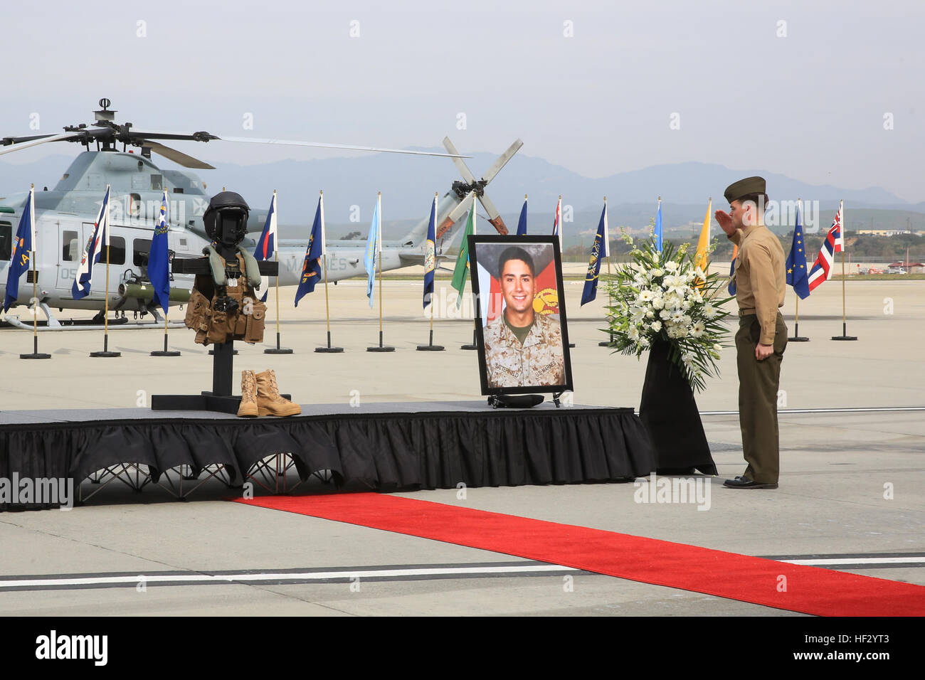 A U.S. Marine assigned to Marine Light Attack Helicopter Squadron (HMLA) 169, Marine Aircraft Group 39, 3rd Marine Aircraft Wing, salutes a memorial to Capt. Adam C. Satterfield, a UH-1Y Venom 'Super Huey' co-pilot, during his memorial service on Marine Corps Base Camp Pendleton, Calif., Feb. 20, 2015. Satterfield and Maj. Elizabeth R. Kealy, a UH-1Y Venom 'Super Huey' pilot, passed away when their helicopter crashed during a training exercise at Marine Corps Air Ground Combat Center Twentynine Palms. (U.S. Marine Corps photo by Cpl. Darien J. Bjorndal, 3rd Marine Aircraft Wing/Released) Maj.  Stock Photo