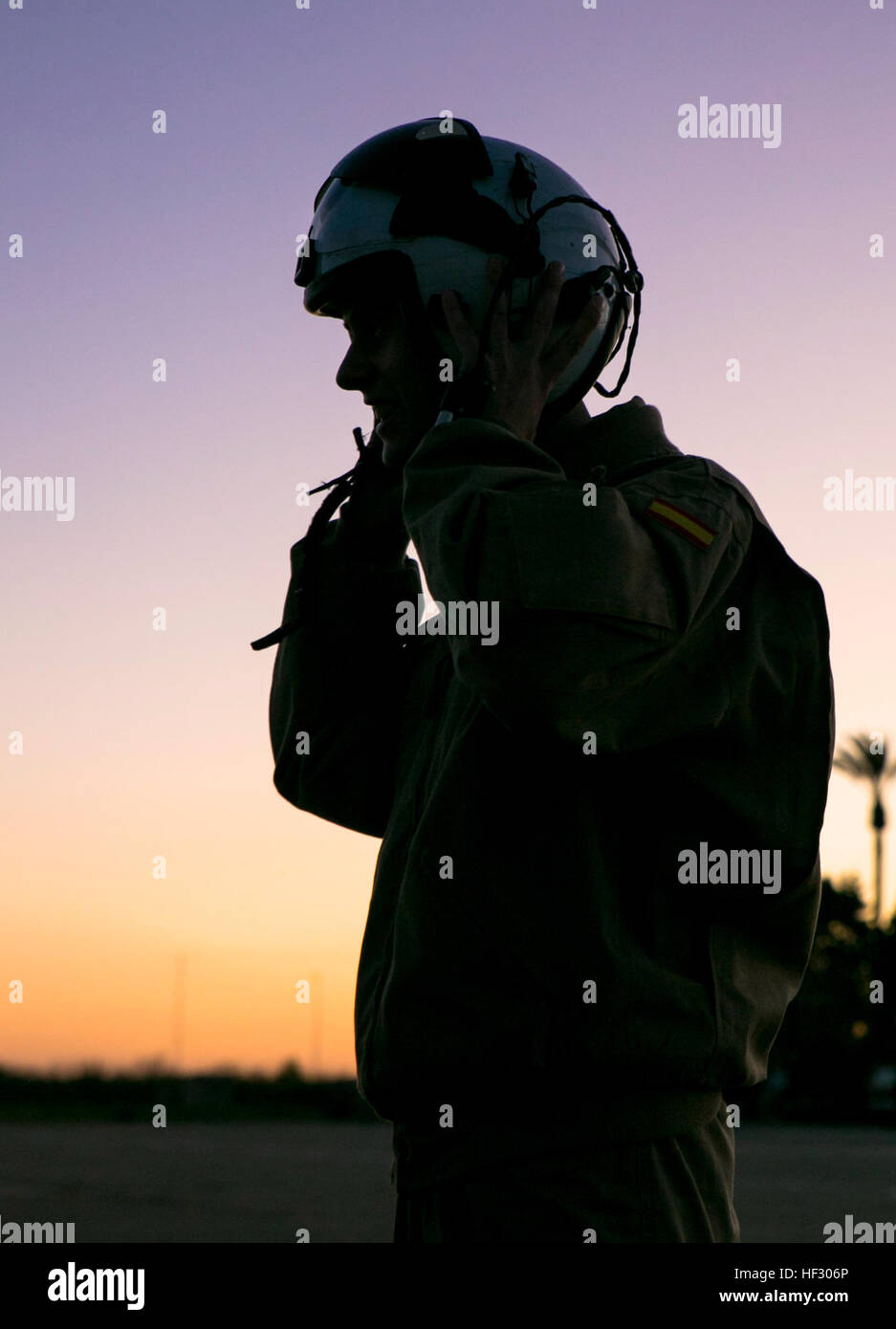 A Spanish pilot with Bhelma IV dons an aviator’s helmet before flying