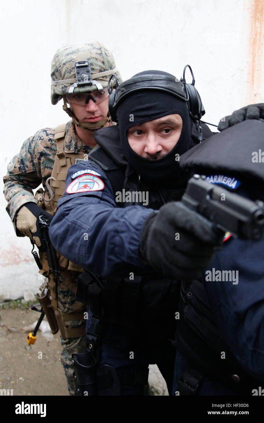 U.S. Marine Cpl. Vincenzo Povero from Alpha Fleet Anti-terrorism Security Team Company Europe (FASTEUR), Naval Station Rota, follows members of the Romanian Jarndarmeria as they demonstrate room-clearing techniques at the Training Center of the Romanian Jandarmeria Special Intervention Brigade in Bucharest, Romania, Feb. 25, 2015. The demonstration was held in conjunction with training at the U.S. Embassy Bucharest that provided FASTEUR Marines a chance to conduct training on reinforcing an American embassy with host nation forces in case of a crisis. (U.S. Marine Corps photo by Sgt. Esdras Ru Stock Photo