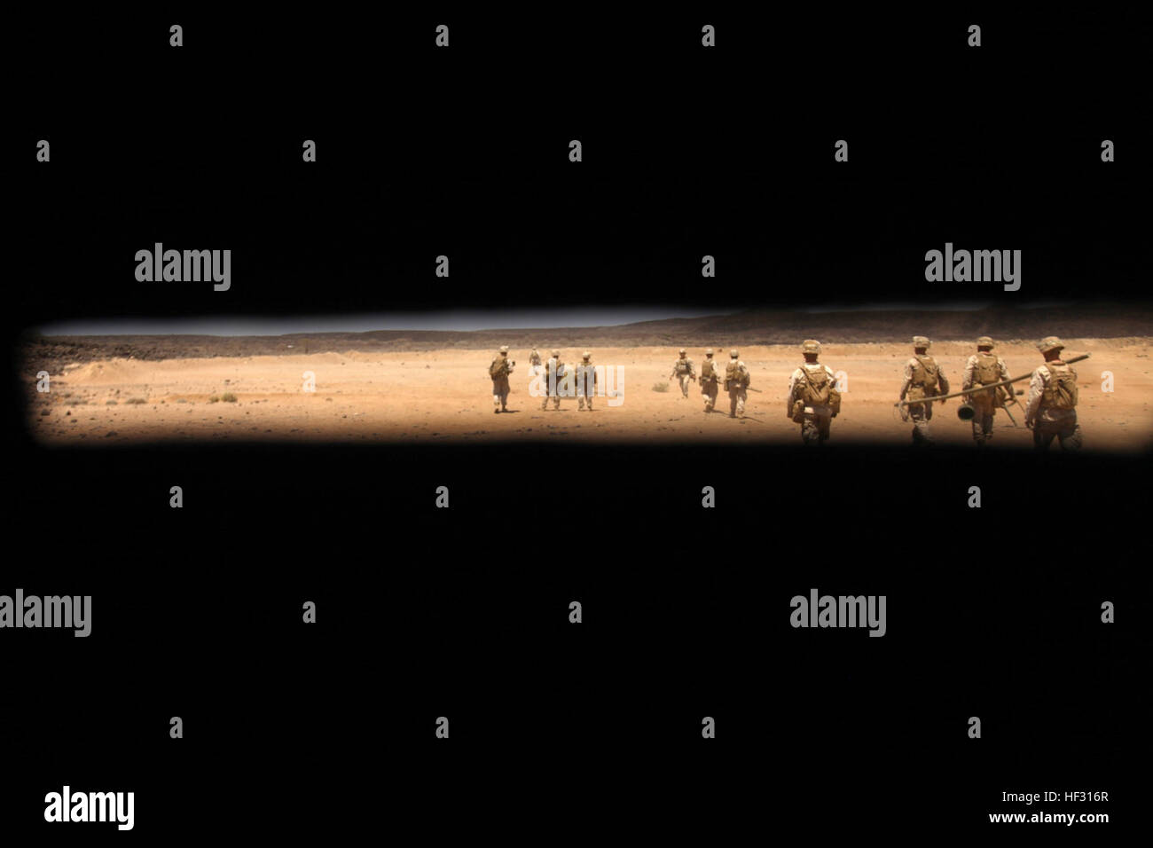 Marines with the 24th Marine Expeditionary Unit’s Battalion Landing Team 3rd Battalion, 6th Marine Regiment and Combat Logistics Battalion 24 are seen carrying explosives through the eye hole of a demolition bunker during a demolition range in Djibouti, March 4, 2015. A contingent of MEU Marines was ashore in Djibouti as part of sustainment training to maintain proficiency while deployed. The 24th MEU is embarked on the ships of the Iwo Jima Amphibious Ready Group and deployed to maintain regional security in the U.S. 5th Fleet area of operations. (U.S. Marine Corps photo by Lance Cpl. Austin  Stock Photo