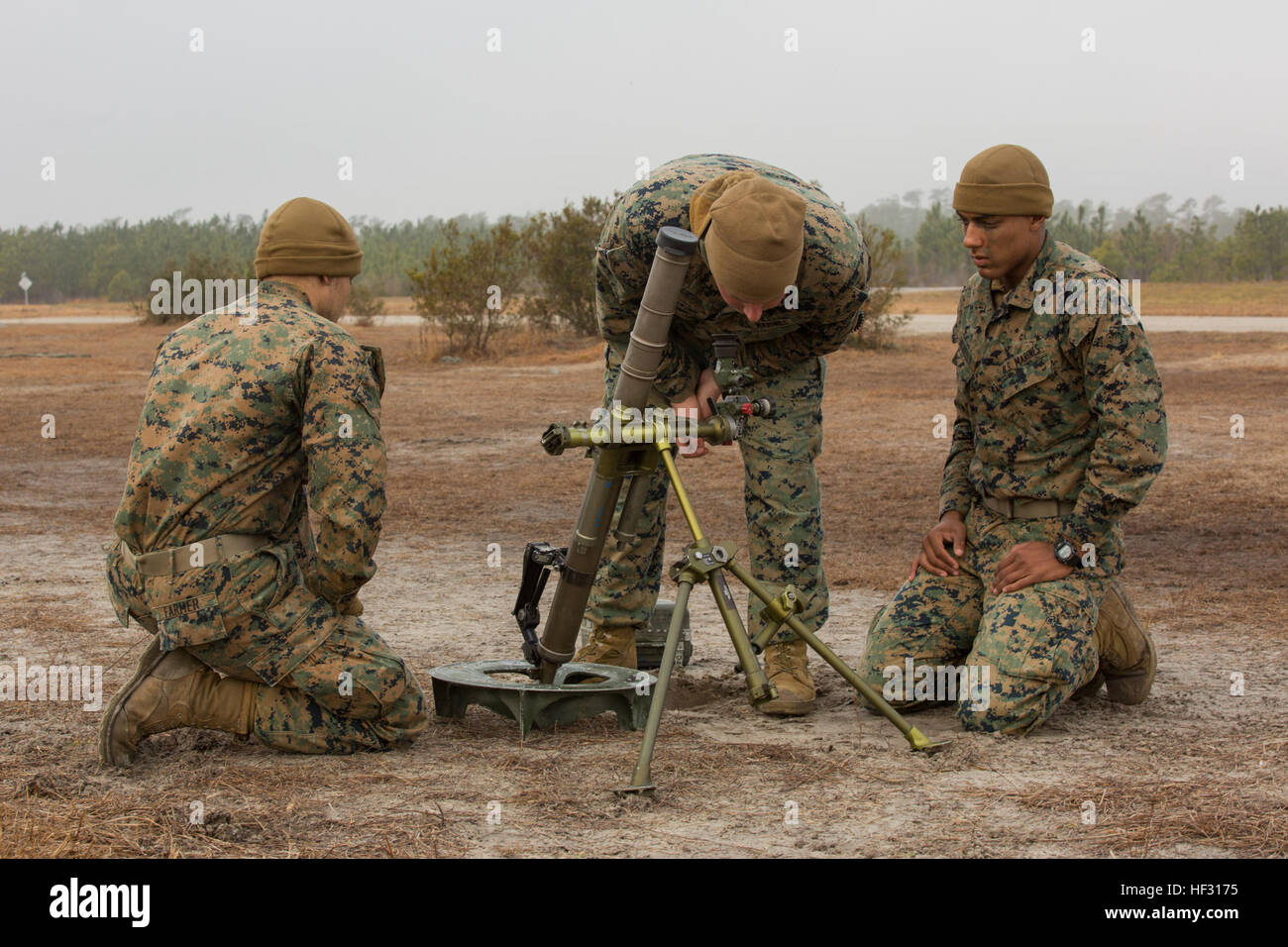 Cpl. Macabe N. Geurkink, a squad leader with Alpha Company, 1st Battalion, 2nd Marine Regiment, checks the work of his junior Marines after conducting drills during a field exercise aboard Camp Lejeune, N.C., March 4, 2015. The drills were intended to better familiarize the Marines with their weapons for quick and accurate engagement when in a deployed environment. (U.S. Marine Corps photo by Lance Cpl. Olivia McDonald/Released) High demands, no pressure, 1-2 prepares for Pacific assignment 150304-M-VS306-023 Stock Photo