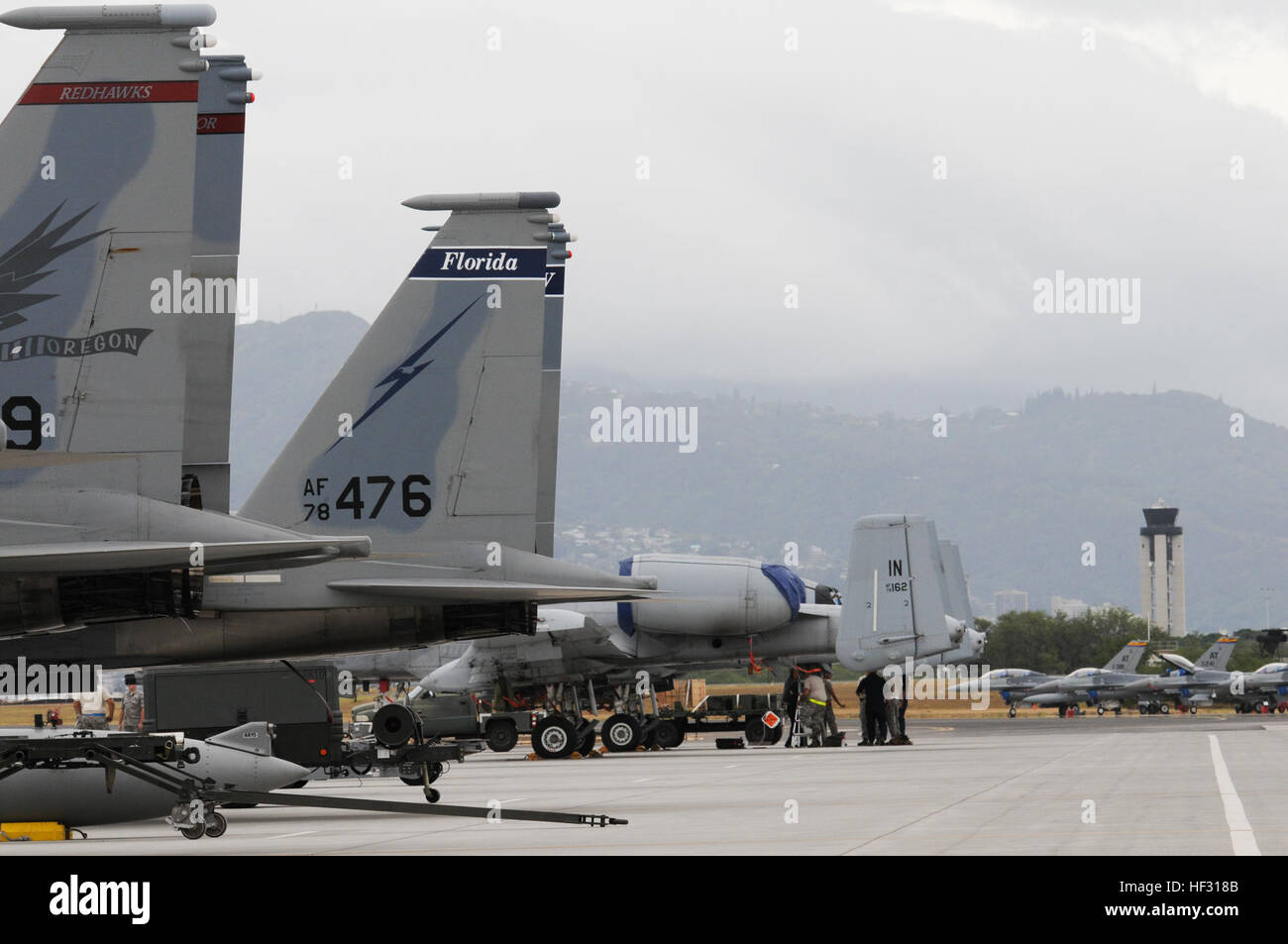 F-15 Eagles from Oregon and Florida, and A-10 Thunderbolts and F-16 Fighting Falcons from Arizona line the flight line at Joint Base Pearl Harbor-Hickam, Hawaii, March 4, 2015. The aircraft are participating in the Hawaii Air National Guard's Sentry Aloha fighter exercise. Sentry Aloha's mission is to provide the ANG, Air Force and DOD counterparts with multifaceted, realistic and integrated training to equip the warfighter with the skillsets necessary to fly, fight and win. (U.S. Air National Guard photo by Senior Airman Orlando Corpuz) Sentry Aloha pits fighter vs. fighter 150304-Z-PW099-006 Stock Photo
