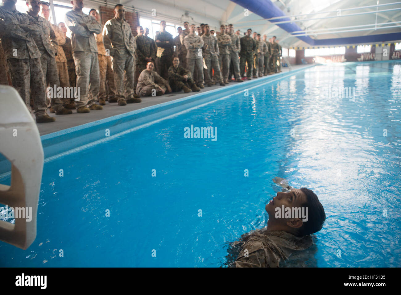 Corporal Andy Orozco, the assistant Marine Corps Instructor of Water Survival for the swim qualification, demonstrates various swimming techniques to the Marines being tested aboard Marine Corps Base Camp Lejeune, March 5, 2015. Marines have to get re-certified in water survival every two years on active duty, or every three years if they pass the intermediate swim qualification. (Official Marine Corps photo by Cpl. Scott W. Whiting) Marines get their feet wet during swim qualification 150305-M-FD819-419 Stock Photo