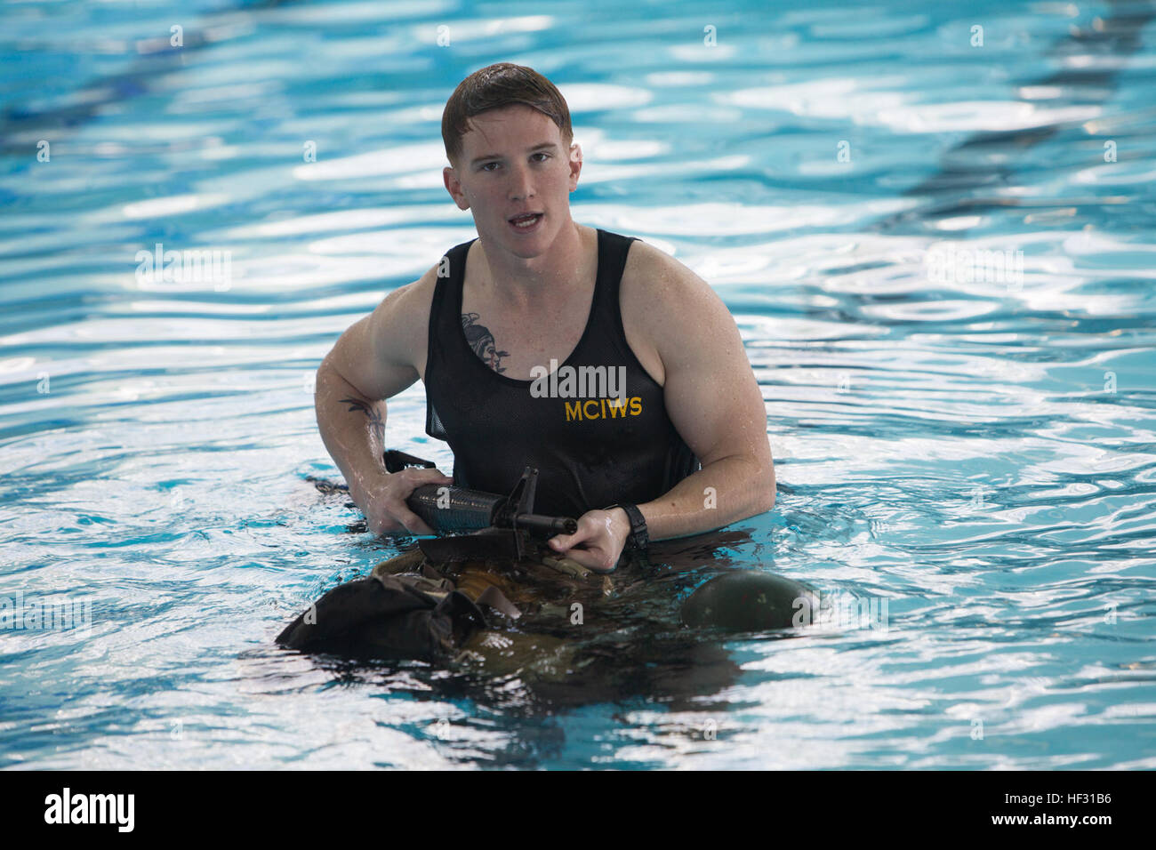 Sergeant Cole Long, the lead Marine Corps Instructor of Water Survival for the swim qualification, explains how to swim with a full combat load during the water survival evaluation aboard Marine Corps Base Camp Lejeune, March 5, 2015. Marines have to get re-certified in water survival every two years on active duty, or every three years if they pass the intermediate swim qualification. (Official Marine Corps photo by Cpl. Scott W. Whiting) Marines get their feet wet during swim qualification 150305-M-FD819-510 Stock Photo