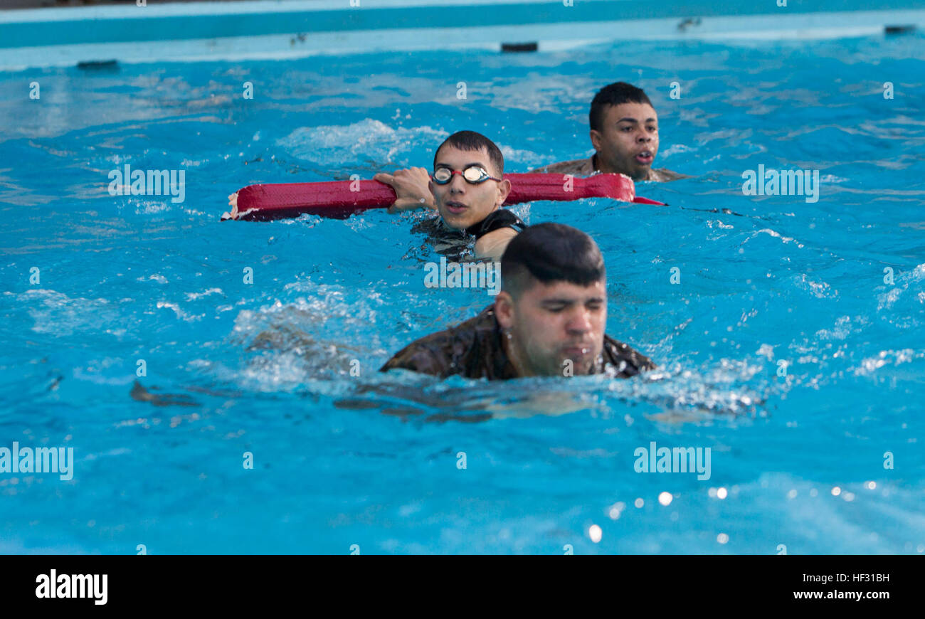 Corporal Andy Orozco, the assistant Marine Corps Instructor of Water Survival for the swim qualification, supervises two Marines in the pool during a swim qualification aboard Marine Corps Base Camp Lejeune, March 5, 2015. Marines have to get re-certified in water survival every two years on active duty, or every three years if they pass the intermediate swim qualification. (Official Marine Corps photo by Cpl. Scott W. Whiting) Marines get their feet wet during swim qualification 150305-M-FD819-765 Stock Photo