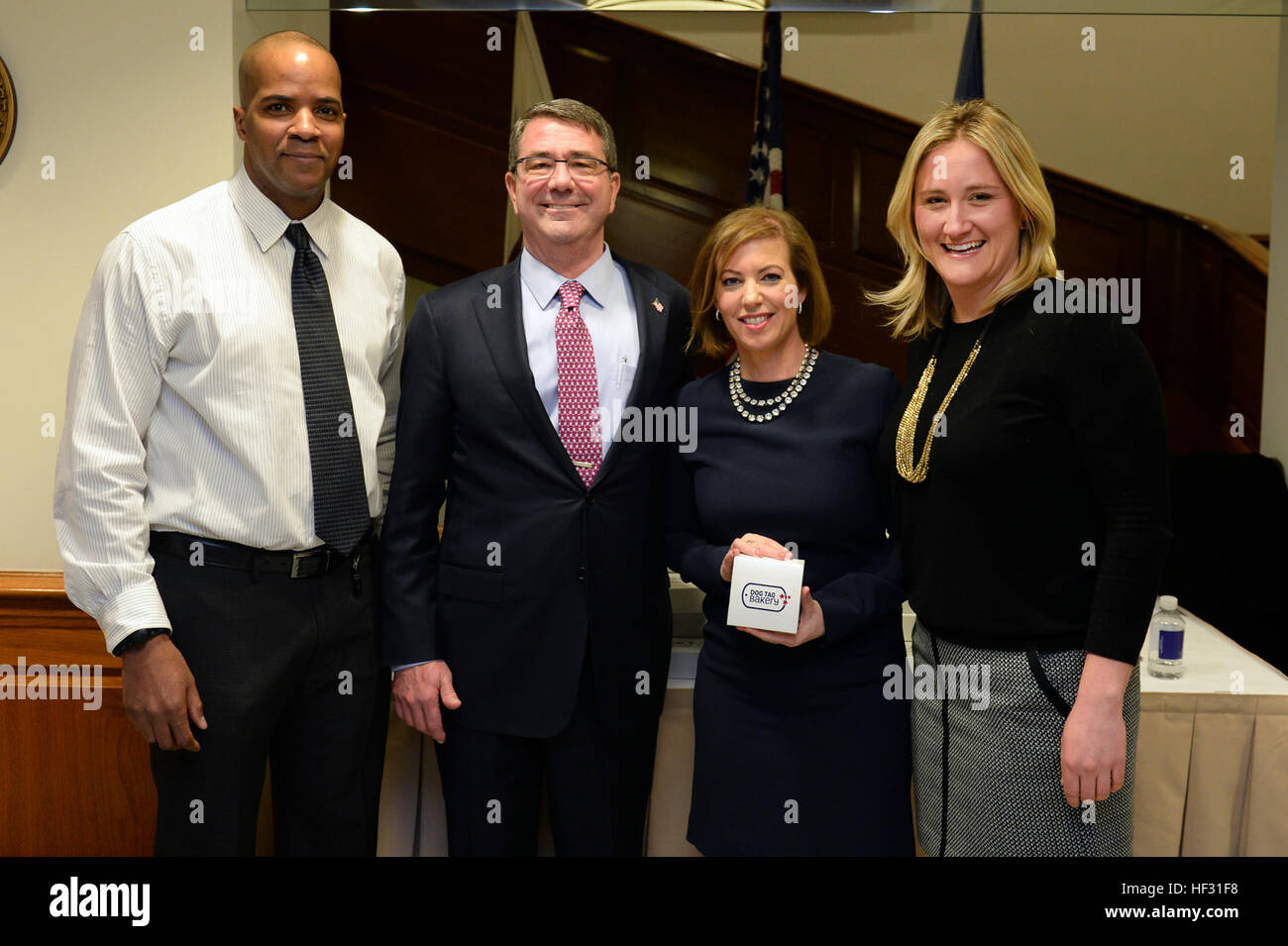 Secretary of Defense Ash Carter and his wife Stephanie pose for a photo with members of the Dog Tag Bakery at the Pentagon March 6, 2015, during a swearing in ceremony reception in honor of Secretary Carter. (Photo by Master Sgt. Adrian Cadiz/Released) SD swearing in ceremony 150306-D-DT527-392 Stock Photo