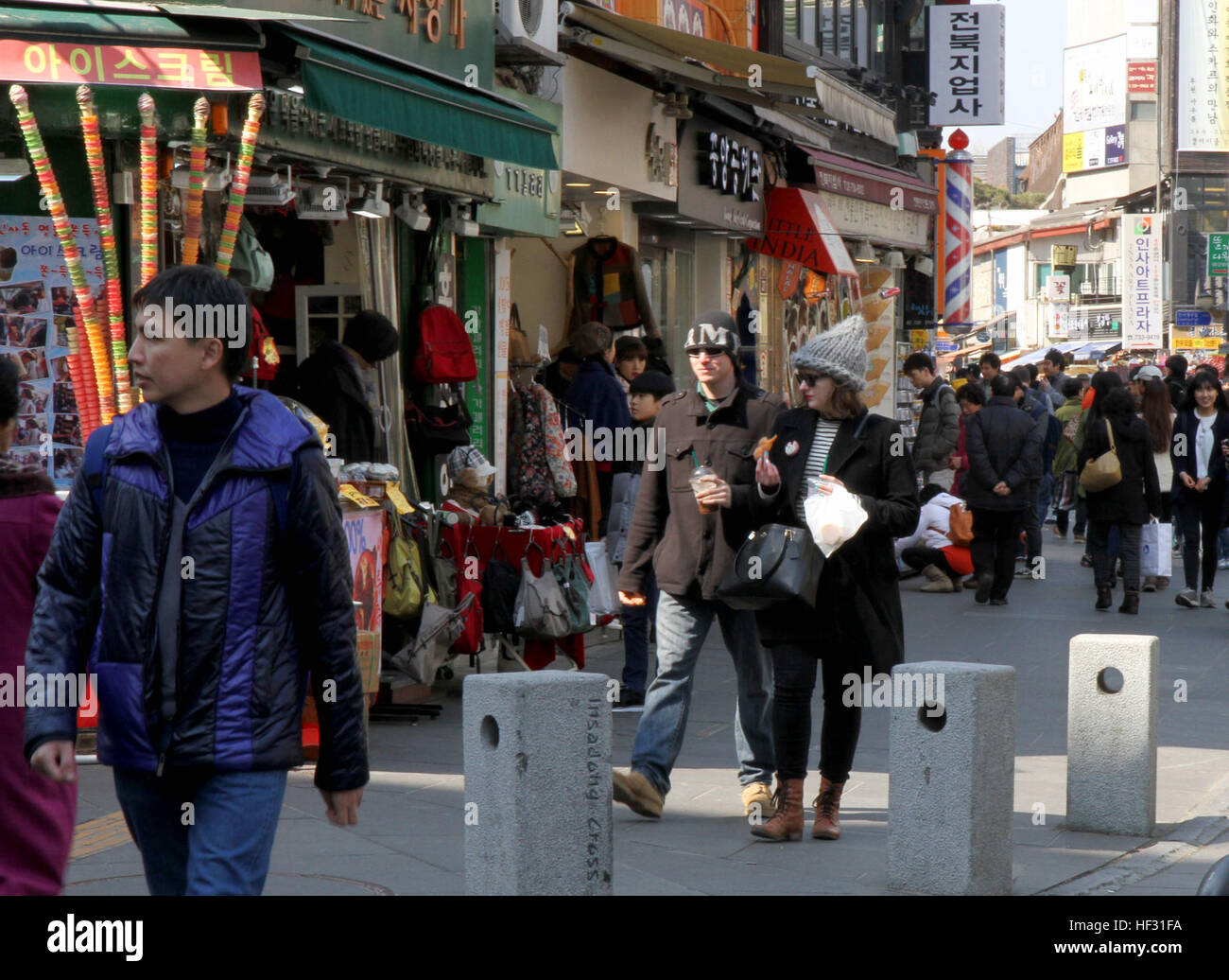 Staff Sgt. Matthew Keeler, a native of Mechanicsburg, Pa., and a public affairs specialist with the 109th Mobile Public Affairs Detachment, Pennsylvania Army National Guard, strolls through the Nam Dae Mun market area of Seoul, South Korea, with his sister, Samantha Keeler, on March 6, 2015. Keeler had the opportunity to spend a day with his sister, who teaches English at a Korean secondary school, during a break in his annual training in support of exercise Key Resolve 2015, part of which took place in Yongsan Garrison. Siblings meet in Seoul 150306-Z-AD415-093 Stock Photo