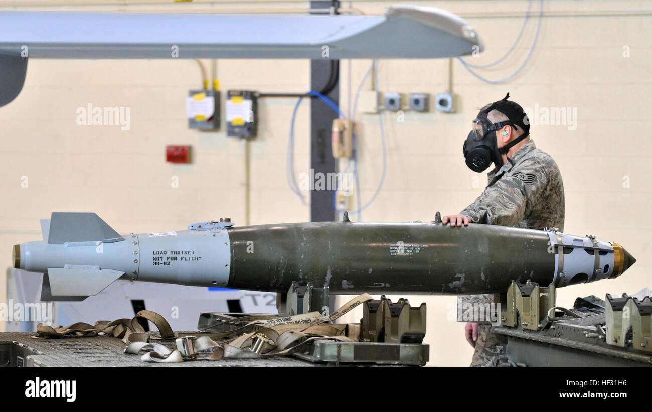 Members of the 174th Attack Wing Munitions Flight train on loading procedures on March 7, 2015, at Hancock Field Air National Guard Base. The munition load crew must be certified quarterly on transporting, loading and wiring munitions onto the MQ-9 Reaper that precisely hit specific targets. The MQ-9 Reaper is an armed, multi-mission, medium-altitude, long-endurance remotely piloted aircraft that is employed primarily for intelligence, surveillance and reconnaissance (ISR). Military intelligence is a military discipline that collects information and analysis to provide guidance and direction t Stock Photo