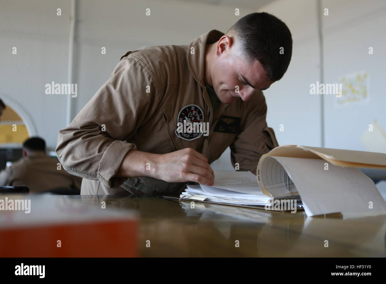 U.S. Marine Corps Capt. John P. Gellinne, a pilot assigned to Marine Aerial Refueler Transport Squadron (VMGR) 252, examines a flight plan in preparation for a Flight In Support of a Deployed Unit (FISDU) at Marine Corps Air Station Cherry Point, N.C., March 8, 2015. The FISDU was conducted to support Marines assigned to Special Purpose Marine Air Ground Task Force conducting operations in foreign countries. (U.S. Marine Corps photo by Lance Cpl. Koby I. Saunders/Released) VMGR-252 Flight In Support of A Deployed Unit 150308-M-AF202-010 Stock Photo