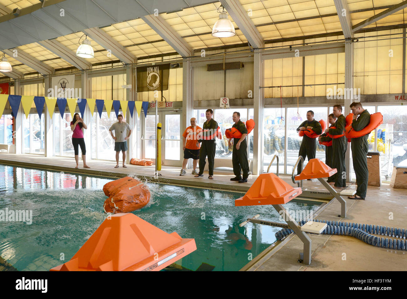 The 108th Wing Airmen deploy a 20-man life raft March 8, 2015, at the Joint Base McGuire-Dix-Lakehurst, N.J., pool. Aircrew members must receive continuation training every 36 months. The Aircrew Flight Equipment instructors, from the 108th Operations Support Squadron, teach aircrew members how to use the safety equipment on their aircraft. (U.S. Air National Guard Photo by Airman 1st Class Julia Pyun/Released) Water survival training 150308-Z-VC328-076 Stock Photo