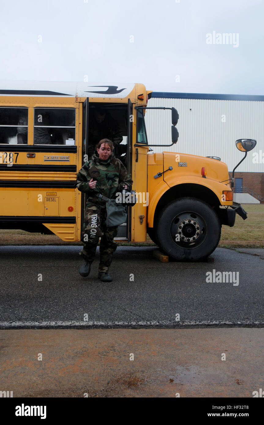 Staff Sgt. Abby Drefke, 185th Air Refueling Wing emergency manager, exits a bus filled with non-lethal chlorobenzalmalononitrile gas, or CS gas, during the Global Dragon deployment for training at the Guardian Center, Perry, Ga., March 12, 2015. CS gas, also known as tear gas, was discovered by Ben Corson and Roger Stoughton in 1928. (U.S. Air National Guard photo by Senior Airman Cody Martin/released) Global Dragon deployment for training 150312-Z-LK614-127 Stock Photo