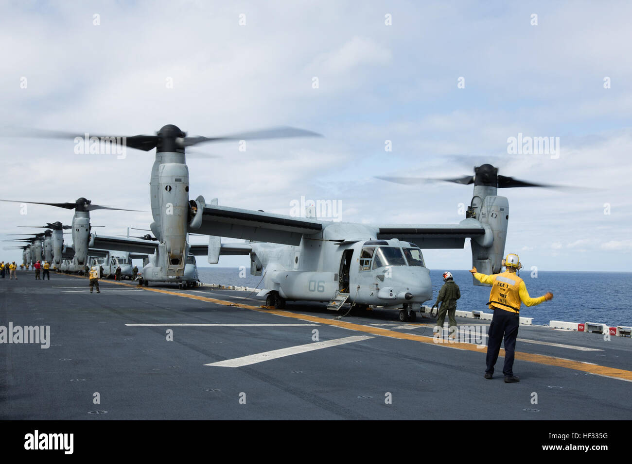 Eight U.S. Marine Corps MV-22B Ospreys prepare for liftoff during flight operations on the USS Bonhomme Richard (LHD 6), at sea, March 13, 2015. The Ospreys are with Marine Medium Tiltrotor Squadron (VMM) 262 (Reinforced), 31st Marine Expeditionary Unit (MEU). VMM-262 (REIN) is the aviation combat element for the 31st MEU. The 31st MEU is participating in amphibious integration training with the Bonhomme Richard Amphibious Ready Group during their Spring Patrol of the Asia-Pacific region. (U.S. Marine Corps photo by Staff Sgt. Joseph DiGirolamo/Released) Ospreys Transport Marines to Airfield S Stock Photo