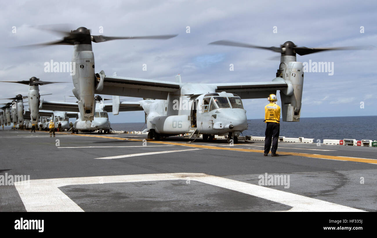 Eight U.S. Marine Corps MV-22B Ospreys prepare for liftoff during flight operations on the USS Bonhomme Richard (LHD 6), at sea, March 13, 2015. The Ospreys are with Marine Medium Tiltrotor Squadron (VMM) 262 (Reinforced), 31st Marine Expeditionary Unit (MEU). VMM-262 (REIN) is the aviation combat element for the 31st MEU. The 31st MEU is participating in amphibious integration training with the Bonhomme Richard Amphibious Ready Group during their Spring Patrol of the Asia-Pacific region. (U.S. Marine Corps photo by Staff Sgt. Joseph DiGirolamo/Released) Ospreys Transport Marines to Airfield S Stock Photo